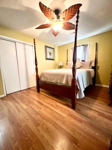 a bedroom with a bed with a ceiling fan at A Cozy Spot on Montague in Charleston