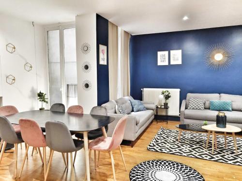 a living room with a table and a couch at Quiet apartment near Saint-Lazarre - 10P in Paris