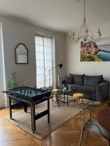 a living room with a ping pong table at Grand studio lumineux en plein coeur de Versailles in Versailles