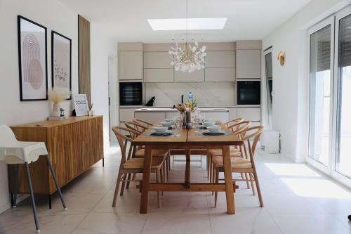 a kitchen and dining room with a wooden table and chairs at Komfortables Penthouse 200 qm in Langen
