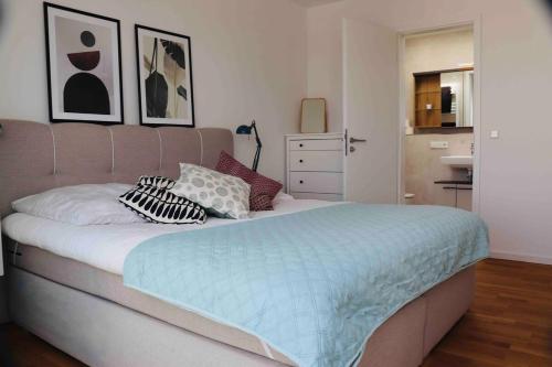 a bedroom with a large bed with pillows on it at Komfortables Penthouse 200 qm in Langen