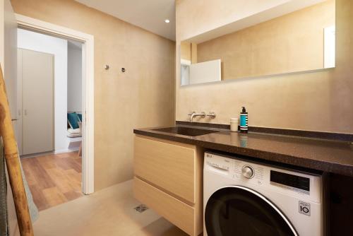 a laundry room with a sink and a washing machine at Crete - Heraklion Sea View Apartment 2 in Heraklio Town