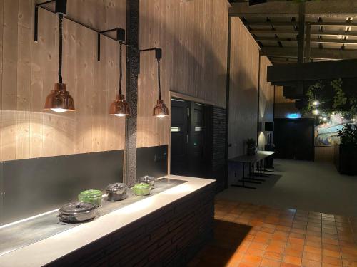 a kitchen with lights on the wall of a building at Spåtind Fjellhotell in Nord Torpa