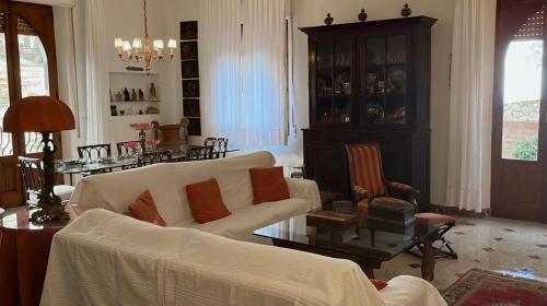 een woonkamer met een bank en een tafel bij CASA LUDOVICA TAORMINA with Sea View Terrace in Taormina