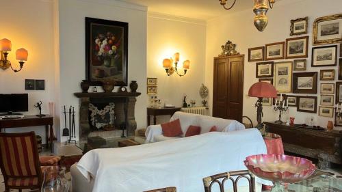 een woonkamer met een bed en een open haard bij CASA LUDOVICA TAORMINA with Sea View Terrace in Taormina