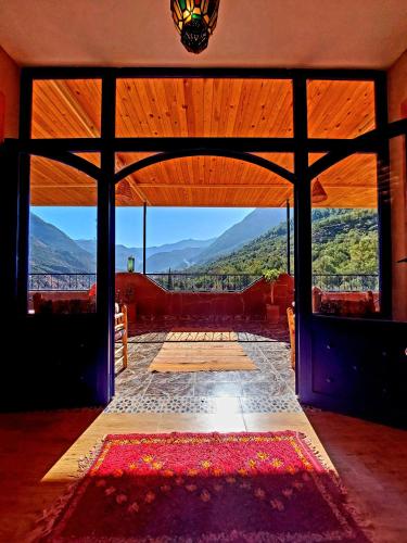 an open door of a building with mountains in the background at DAR EL HACHIMI EL IDRISSI in Ourika