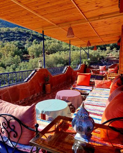 an outdoor patio with couches and tables and chairs at DAR EL HACHIMI EL IDRISSI in Ourika