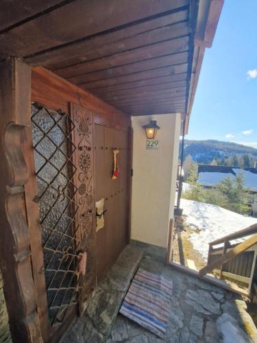 a door to a house with a view of the water at LaLo Alm - Berge erleben in Lachtal
