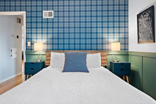 a bedroom with a large bed and two blue cabinets at Urban Lake Life in Minneapolis