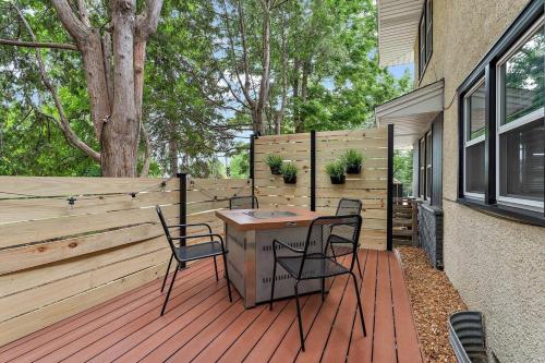 a patio with two chairs and a table on a wooden deck at Urban Lake Life in Minneapolis