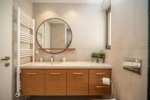 a bathroom with a sink and a mirror at Cozy Spot II near the beach in Ayiá