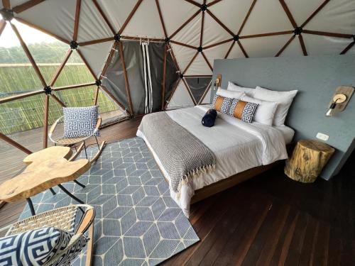 ein Schlafzimmer in einer Jurte mit einem Bett und einem Tisch in der Unterkunft URQU Glamping cerca a Bogota in Silvania