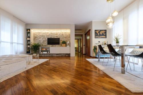 a living room with a table and a dining room at Lussuoso e accogliente appartamento con terrazza in San Donato Milanese