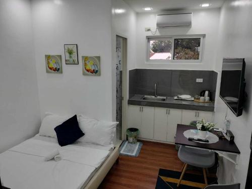 a living room with a white couch and a table at Luna Prime Hub And Inn in Olongapo