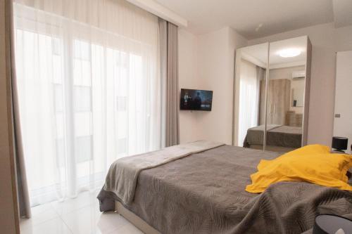 Ένα ή περισσότερα κρεβάτια σε δωμάτιο στο Sea front Apartment