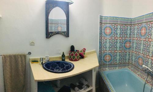 a bathroom with a sink and a bath tub at Casa Azul in Chefchaouene