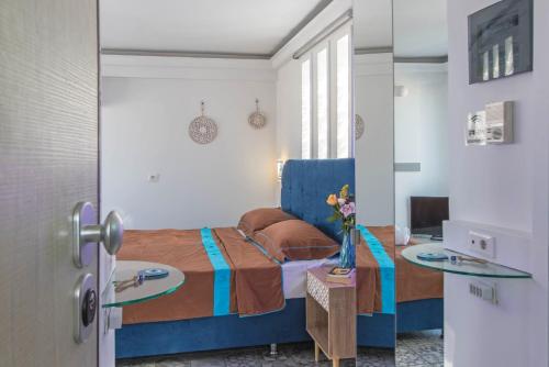 a bedroom with a bed and two glass tables at Parthenon crown penthouse in Athens