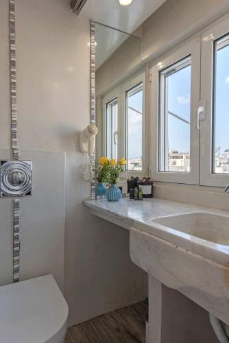 a bathroom with a large sink and a mirror at Parthenon crown penthouse in Athens