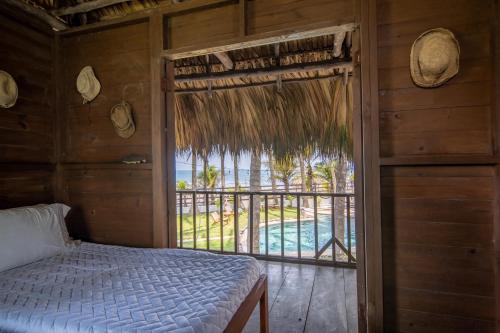 a bedroom with a bed and a view of a pool at Pacifica in Sipacate