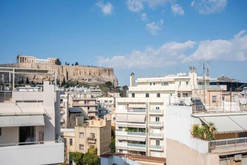 a view of the city of athens from the roofs of buildings at Parthenon crown penthouse in Athens