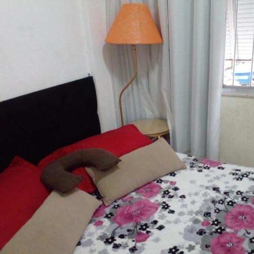 a bed with a stuffed animal on top of it at Copacabana aconchegante e dividido em quarto e sala in Rio de Janeiro