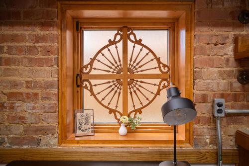a window with a door with a vase on it at Hartwell Suites in Hartwell