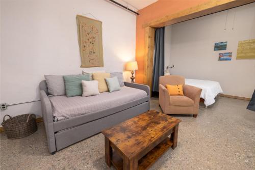 a living room with a couch and a chair at Hartwell Suites in Hartwell