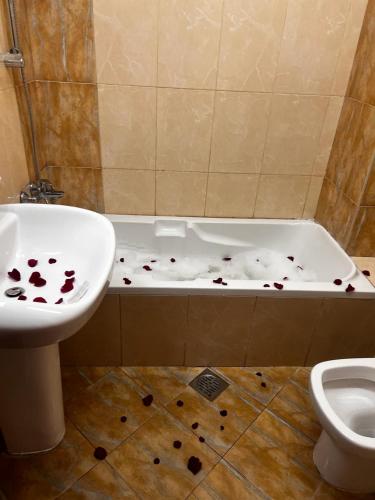 a bathroom with a sink and a bathtub covered in blood at Bliss Spot Vacation Home in Al Ain