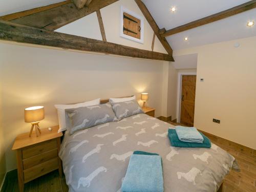 a bedroom with a large bed with blue pillows at 3 bed in Usk 87286 in Llandenny