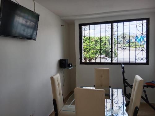 a dining room with a table and a window at PARTAMENTO VALLEDUPAR in Valledupar