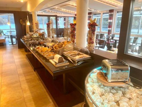a buffet line in a hotel with food on it at Garni Hotel Henn in Simmerath