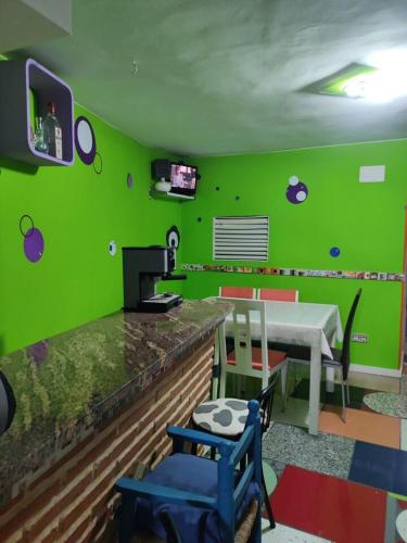 a green room with a table and a green wall at One bedroom house at Las Ventas Con Pena Aguilera in Ventas con Peña Aguilera