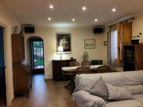 a living room with a couch and a table at Cosy Chalet in L'Arboçar with Private Pool, 65 sqm in Barcelona