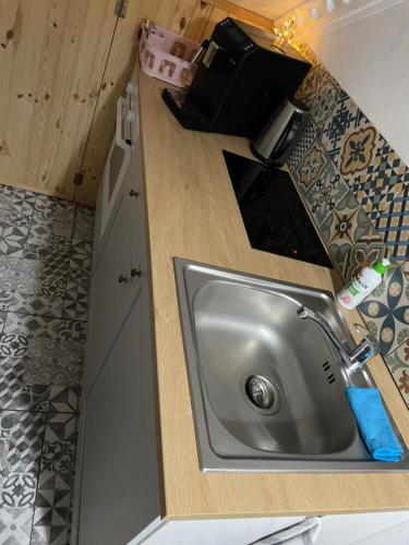 a kitchen counter with a sink in a kitchen at K&B Residence in Jarosław