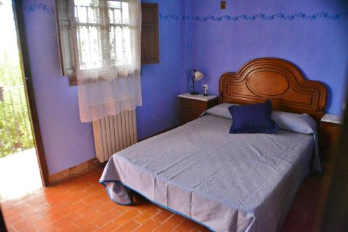 1 dormitorio con 1 cama con pared azul en 5 bedrooms chalet with terrace and wifi at Altura, en Altura