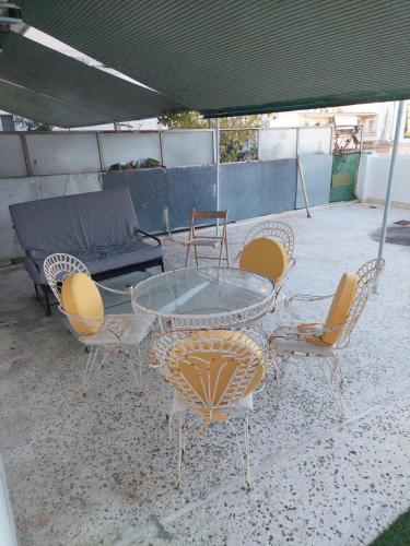 a glass table and chairs under a tent at Maria Louiza apartment NEAR CENTER in Athens