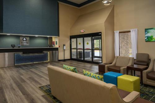 a waiting area with a couch and chairs in a waiting room at Quality Inn & Suites Lexington South in Lexington