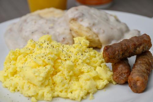a plate of scrambled eggs and sausage and bread at Quality Inn & Suites Lexington South in Lexington