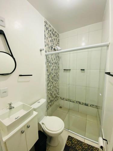 a white bathroom with a toilet and a sink at DuPai 10 Sorocaba in Sorocaba