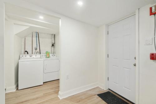 a bathroom with white walls and a white door at Silverwood Serenity: Large 2b 2b with Parking in Philadelphia