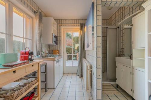 een keuken met witte kasten en een groot raam bij One bedroom property with terrace and wifi at Courcelles in Courcelles