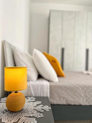 a yellow lamp sitting on a table next to a bed at Marina Apartments in Msida