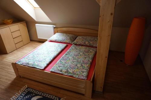 A bed or beds in a room at Domek Šumava