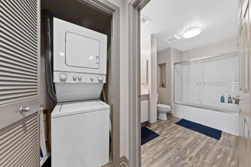a bathroom with a sink and a toilet and a tub at Venice Beach Lux Retreat Coastal Apartment Haven in Los Angeles