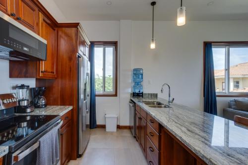 a kitchen with wooden cabinets and a counter top at Seiri del Mar in Hopkins