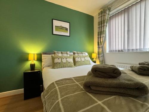 a bedroom with a bed with towels on it at Hambleton Hideaway in Stokesley