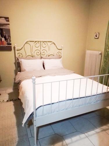 a bedroom with a white bed in a room at Despina's House in Chrysoupolis