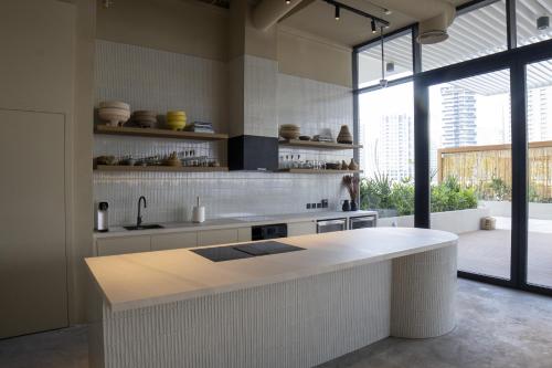 a kitchen with a white counter and a large window at Business Travel Ready Studio at Upside Living in Dubai