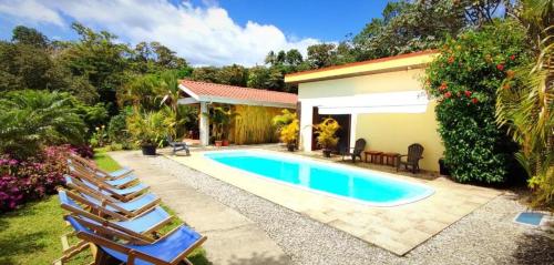 - une piscine en face d'une maison dans l'établissement Arenal Villas Tranquilas, free-standing equipped houses, à Nuevo Arenal