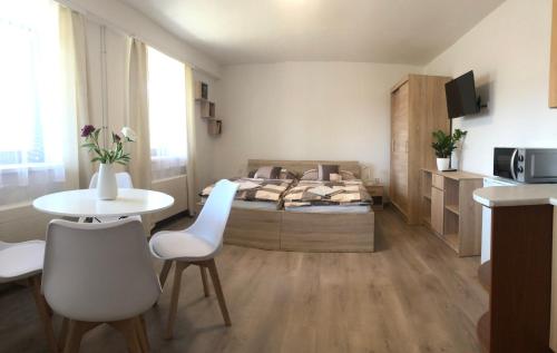 - une chambre avec un lit, une table et des chaises dans l'établissement Apartmán PodFaustinkou, à Sušice